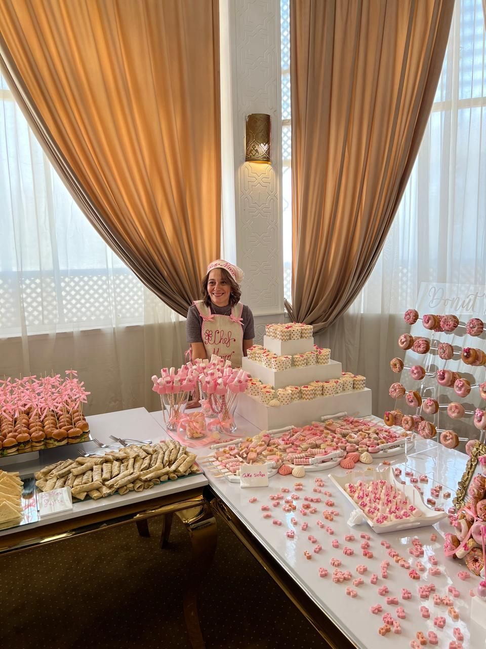 Chef Maro of Chez Maro, standing behind a signature dessert display